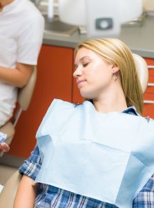 woman asleep in the dental chair from dental sedation